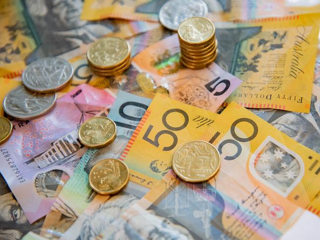 Australian notes and coins spilled out on a table