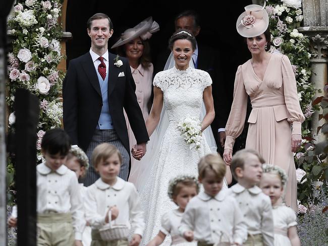 Pippa and James smile as they are joined by the Duchess of Cambridge.