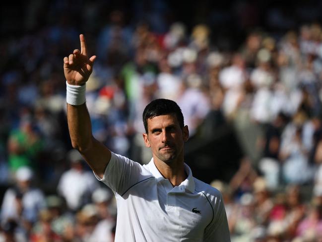 TOPSHOT - Serbia's Novak Djokovic celebrates beating Britain's Cameron Norrie during their men's singles semi final tennis match on the twelfth day of the 2022 Wimbledon Championships at The All England Tennis Club in Wimbledon, southwest London, on July 8, 2022. (Photo by Daniel LEAL / AFP) / RESTRICTED TO EDITORIAL USE