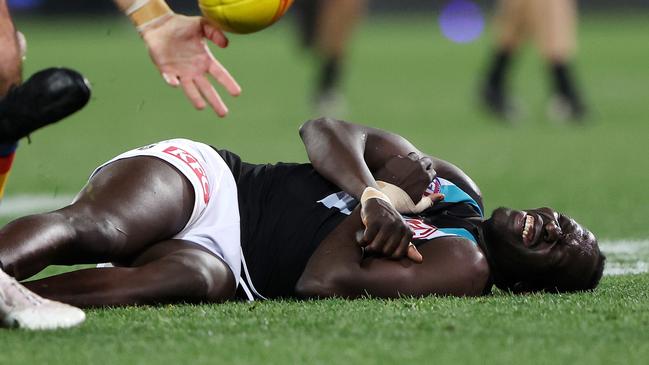 ADELAIDE, AUSTRALIA - JULY 29: Aliir Aliir of the Power down after a collision with Lachie Jones of the Power during the 2023 AFL Round 20 match between the Adelaide Crows and the Port Adelaide Power at Adelaide Oval on July 29, 2023 in Adelaide, Australia. (Photo by Sarah Reed/AFL Photos via Getty Images)