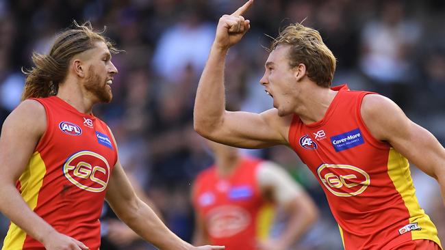 Tom Lynch celebrates a goal with teammates Aaron Young. Picture: AAP