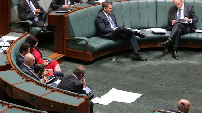 Towels soak up a leak in the roof during Question Time in the House of Representatives in Canberra today.