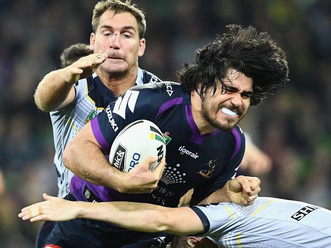 MELBOURNE, AUSTRALIA - JUNE 17:  Tohu Harris of the Storm is tackled during the round 15 NRL match between the Melbourne Storm and the North Queensland Cowbpys at AAMI Park on June 17, 2017 in Melbourne, Australia.  (Photo by Quinn Rooney/Getty Images)