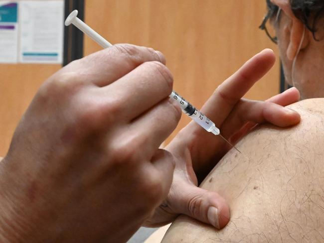 A nurse administers an injection of the Pfizer-BioNtech Covid-19 vaccine to a patient at Zinga Zanga village hall vaccination centre in Beziers, southern France, on March 17, 2021. (Photo by Pascal GUYOT / AFP)