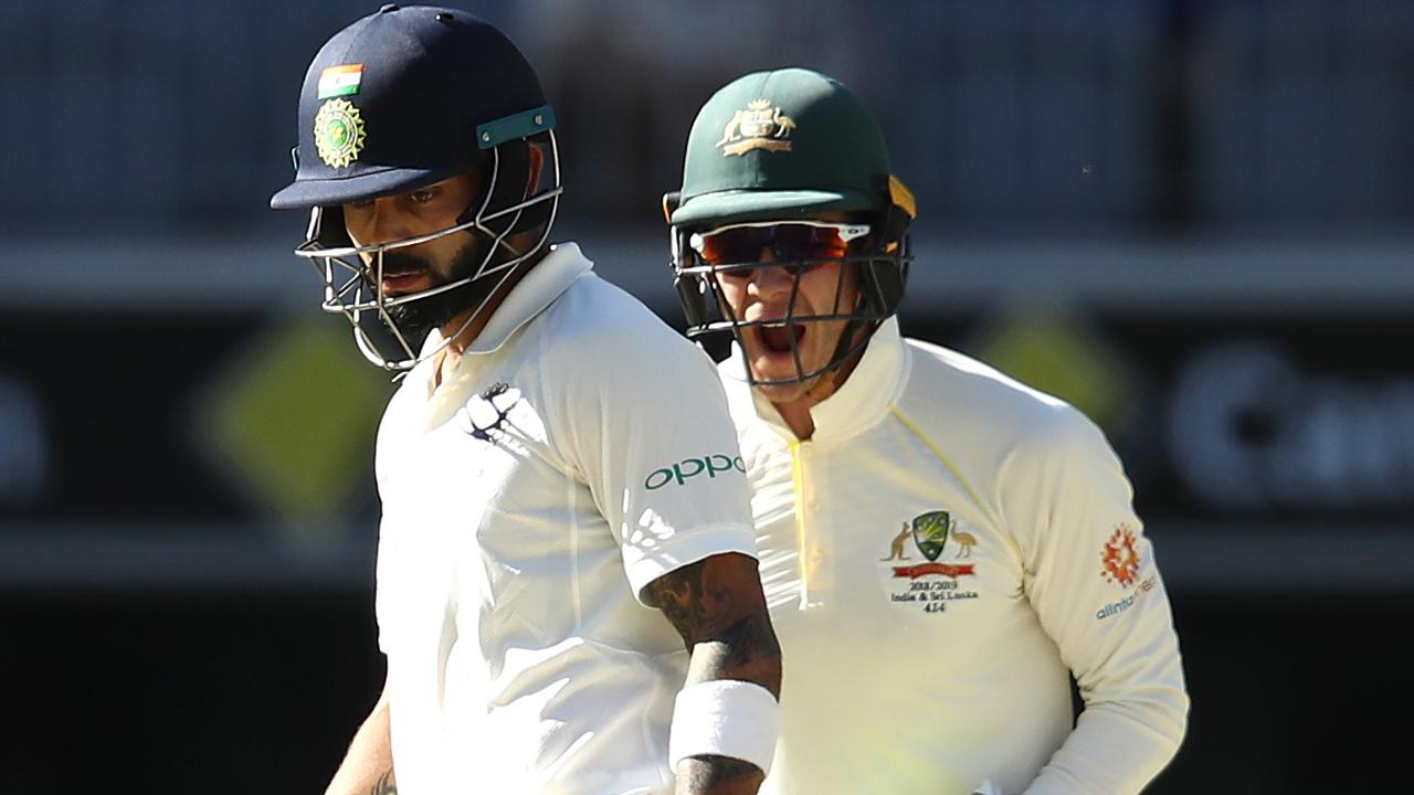 Tim Paine of Australia celebrates as Virat Kohli of India looks dejected after he was dismissed by Nathan Lyon.