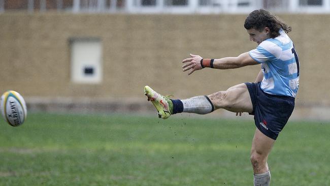 NSW's Zac Safati kicks.