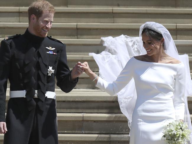 Meghan Markle and Britain's Prince Harry walk down the steps of St George's Chapel at Windsor Castle. Picture: AP