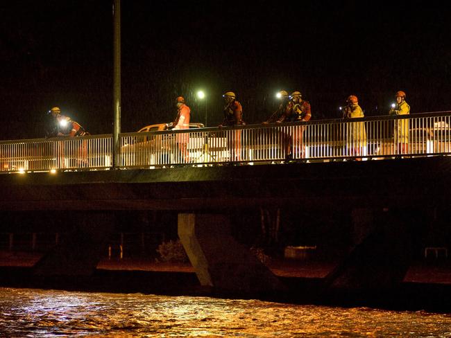 NTES Volunteers line the Stott Terrace bridge with torches searching for the body of a 24-year-old man who drowned. PHOTO: Barry Skipsey