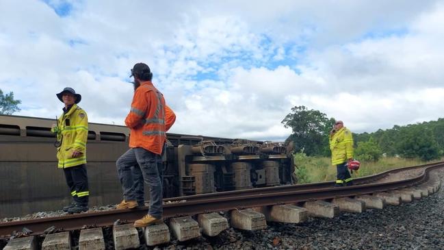 Teams at the site of the train derailment in Nana Glen, west of Coffs Harbour. Around 8000 litres of diesel has leaked out of one of the derailed locomotives.