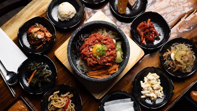 The raw beef bibimbap surrounded by banchan. Picture: David Kelly