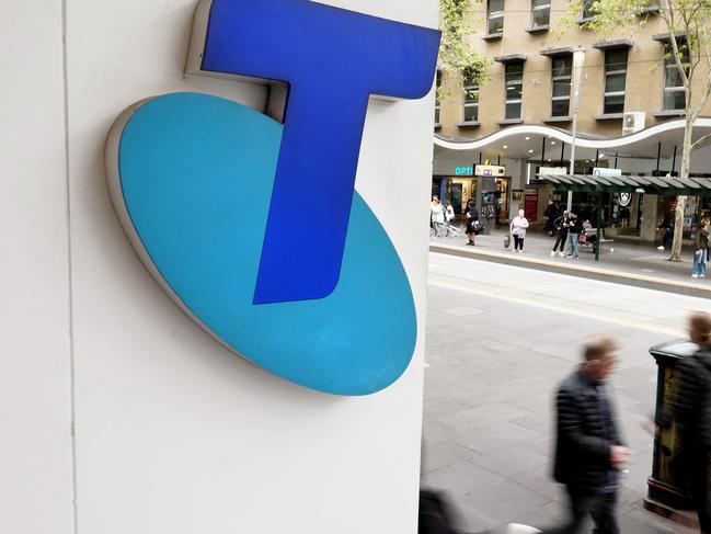 MELBOURNE, AUSTRALIA - NewsWire Photos OCTOBER 4, 2022. Generic photo people walking past the Telstra logo in Melbourne..Picture: NCA NewsWire / Luis Enrique Ascui