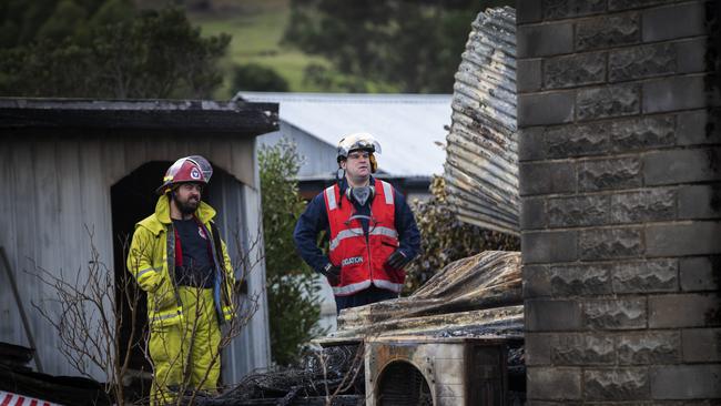 Police and fire investigators at the scene of a house fire at Fourfoot Rd, Geeveston. Picture Chris Kidd