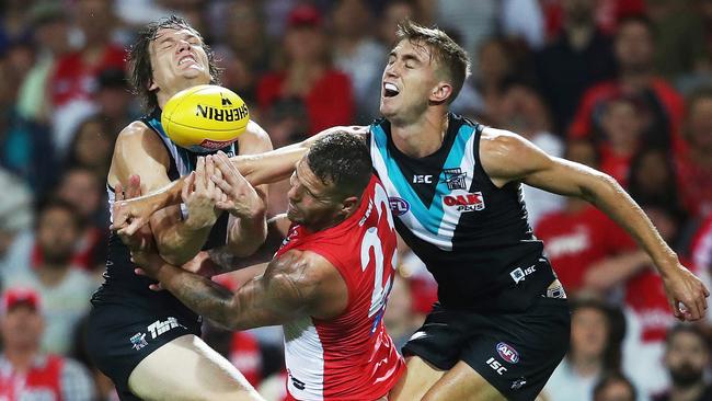 Sydney's Lance Franklin crunched by Port Adelaide's Jared Polec and Dougal Howard on Sunday. Picture: Phil Hillyard