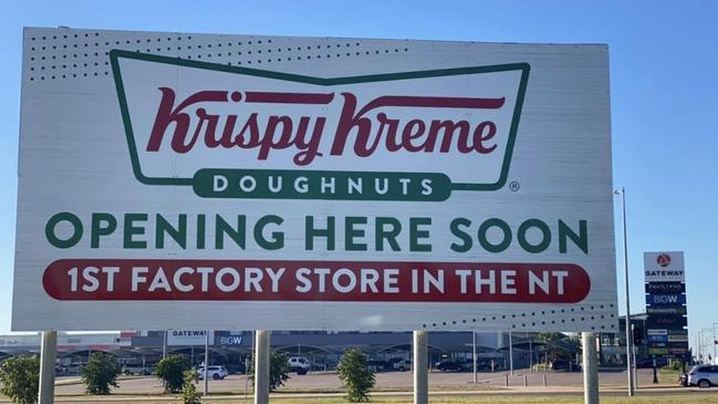 A (now removed) sign heralding the arrival of the Territory’s first Krispy Kreme. Picture: NT News.