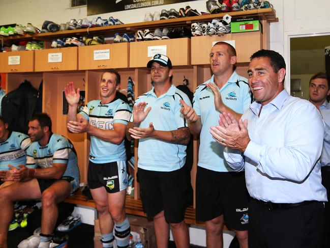 Shane Flanagan joins in the team song in the dressing rooms after his return match as coach.