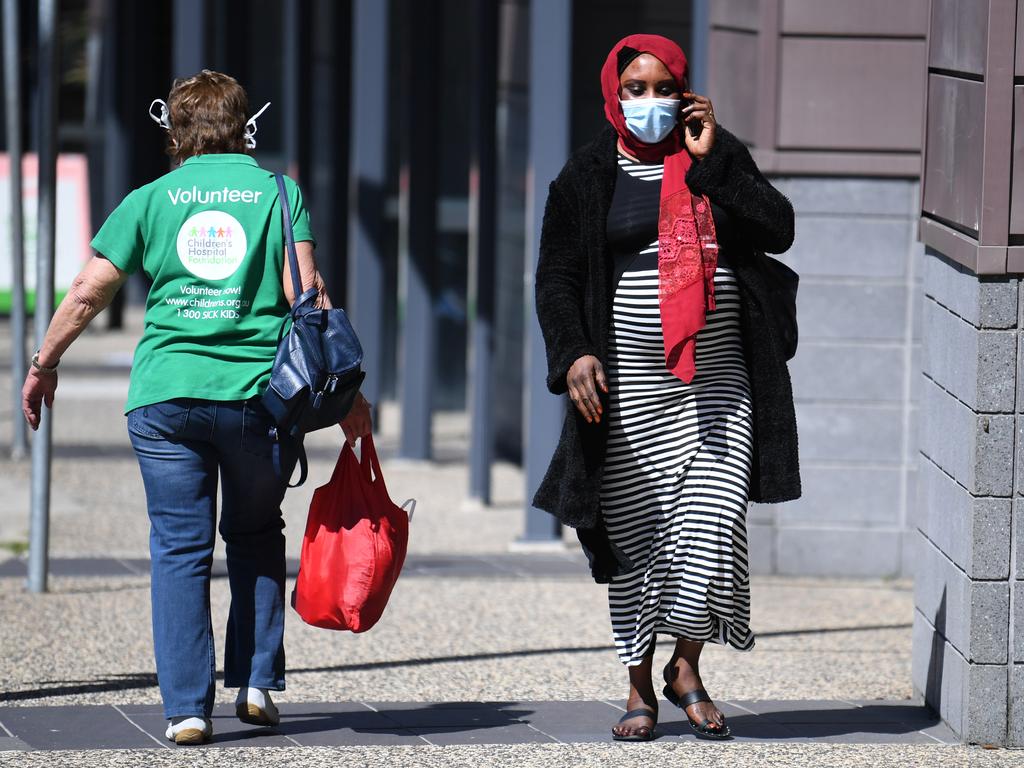 A woman wears a surgical mask outside the Mater Hospital in Brisbane. Picture: NCA NewWire / Dan Peled