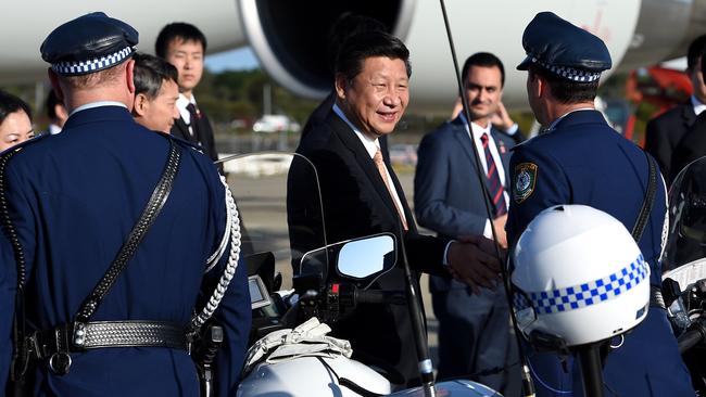 Xi Jinping, (centre), thanks members of the NSW Police motorcycle escort as he departs Sydney. Picture: AAP Image/Dan Himbrechts