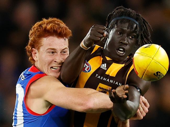 MELBOURNE, AUSTRALIA - JUNE 24: Changkuoth Jiath of the Hawks is tackled by Ed Richards of the Bulldogs during the 2022 AFL Round 15 match between the Western Bulldogs and the Hawthorn Hawks at Marvel Stadium on June 24, 2022 in Melbourne, Australia. (Photo by Michael Willson/AFL Photos via Getty Images)