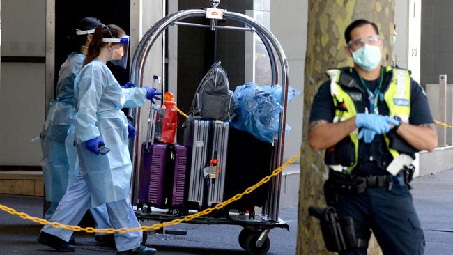 Luggage belonging to quarantined international travellers is loaded onto a coach outside the Holiday Inn on Flinders Lane in Melbourne. Picture: NCA NewsWire / Andrew Henshaw