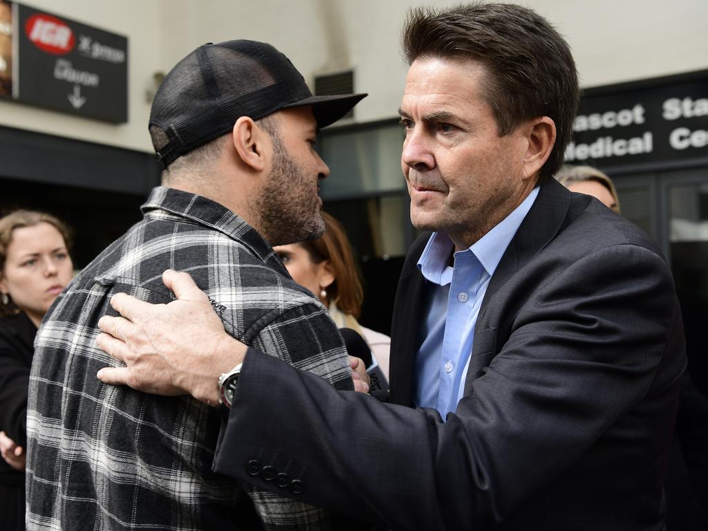 Mascot Towers apartment owner Fabiano Santos embraces NSW Better Regulation Minister Kevin Anderson after he announced a one-off temporary residential accommodation package for displaced residents. Picture: AAP Image/Bianca De Marchi