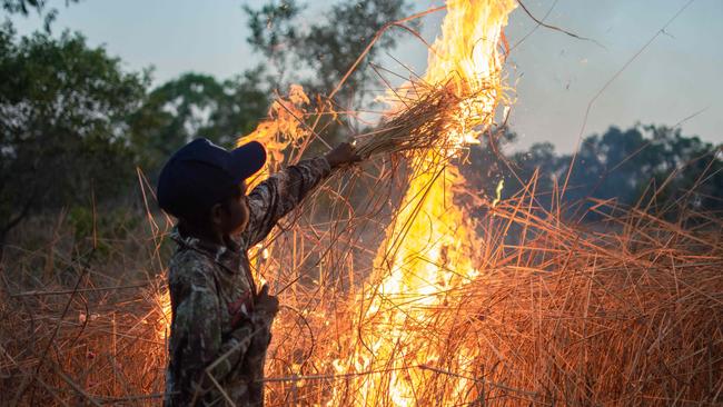 Nawarddeken Academy student Damaziah Nabulwad burning off at Mamadawerre. Picture: Cody Thomas