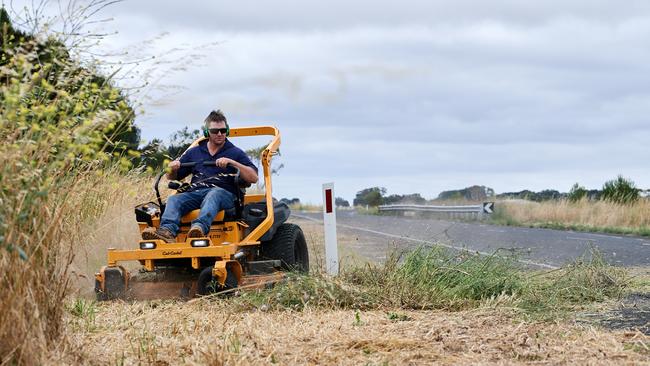 Mark Beggs (pictured) and wife Melissa have taken it on themselves to mow roughly 1.5 km of roadside grass near their property because of bushfire fears. Picture: Frank Monger