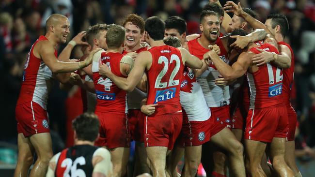 Gary Rohan of the Swans celebrates with his teammates.