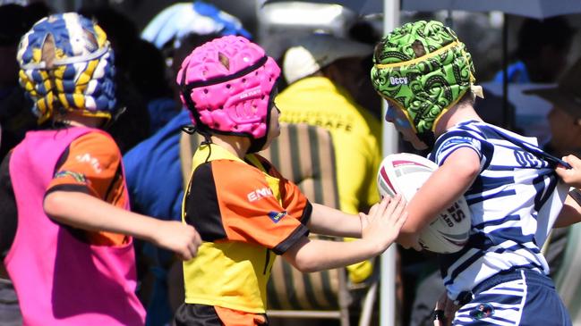 Herbert River Junior Rugby League Crushers Orange U8 player Aston Bye tackles an opponent from Townsville Brothers. Photographs from the Dean Schifilliti Shield rugby league carnival for U8 players at Artie Gofton Oval, Ingham, Hinchinbrook Shire, on Saturday: Pictures: Cameron Bates