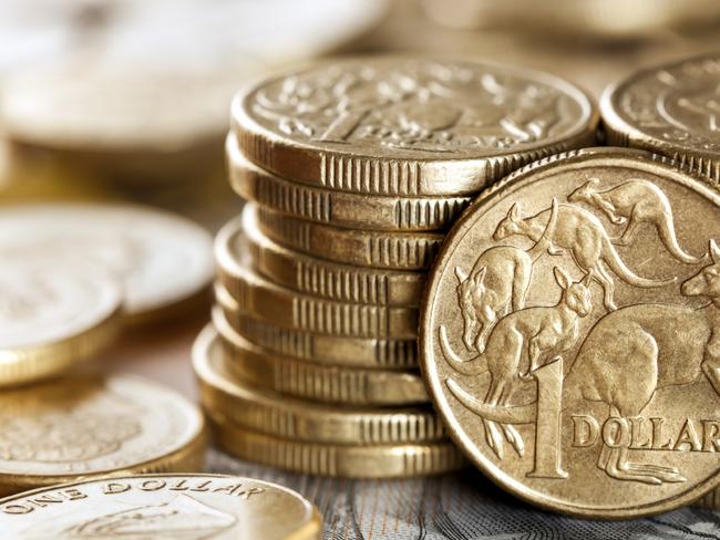 Stacks of Australian one dollar coins. Focus on front coin.