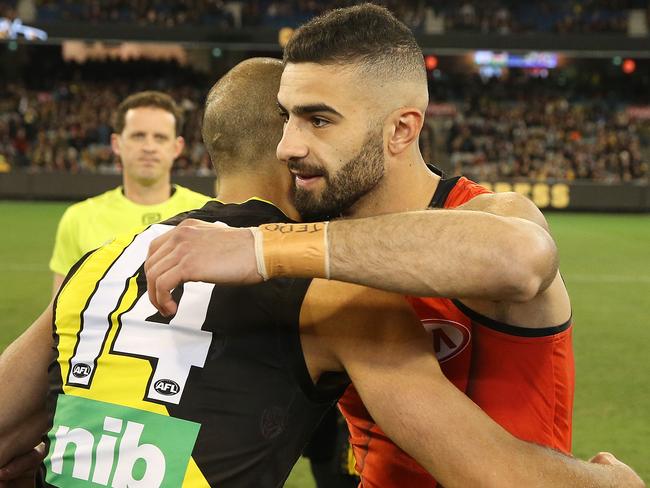 Richmond’s Bachar Houli and Essendon’s Adam Saad embraced at the coin toss on Friday night. Picture: Michael Klein