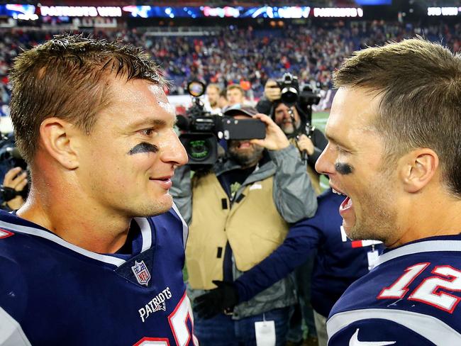 (FILES) In this file photo taken on October 13, 2018 Tom Brady #12 talks to Rob Gronkowski #87 of the New England Patriots after a victory over the Kansas City Chiefs at Gillette Stadium in Foxborough, Massachusetts. - Rob Gronkowski has made a stunning return from retirement to be reunited with former New England Patriots team-mate Tom Brady at the Tampa Bay Buccaneers, reports said on April 21, 2020. (Photo by Adam Glanzman / GETTY IMAGES NORTH AMERICA / AFP)