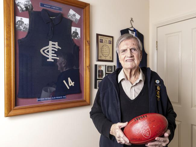 Roger O'Brien with one of his old football jumpers. Photo: Daniel Pockett