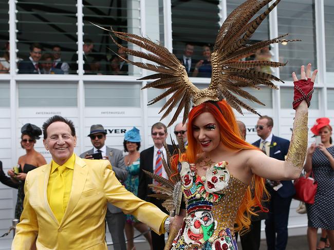 Geoffrey Edelsten and Gabi Grecko walk through the Birdcage in 2014.