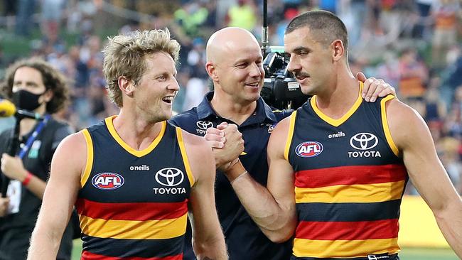 Rory Sloane, Matthew Nicks and Taylor Walker celebrate upsetting Geelong in Round 1 earlier this year. Picture: Sarah Reed/AFL Photos via Getty Images