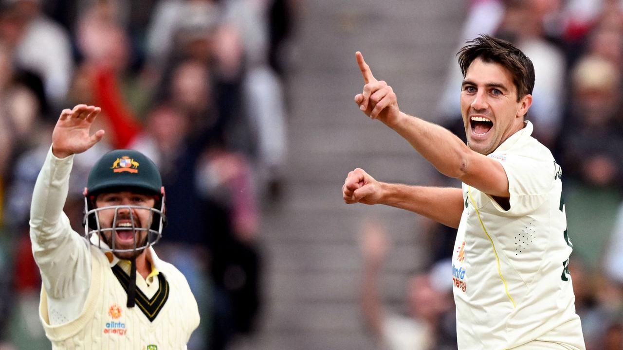 Pat Cummins and Travis Head celebrate Dean Elgar’s dismissal on day three.