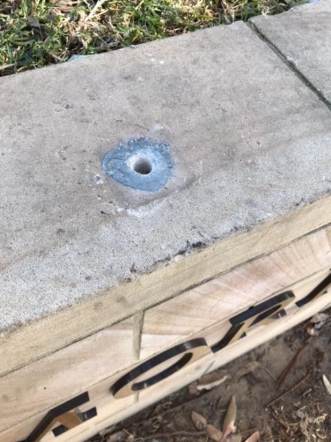 The place where a Quick Reference Reader panel was wrenched from a sandstone wall by vandals along the Anzac Memorial Pathway near Forestville RSL.