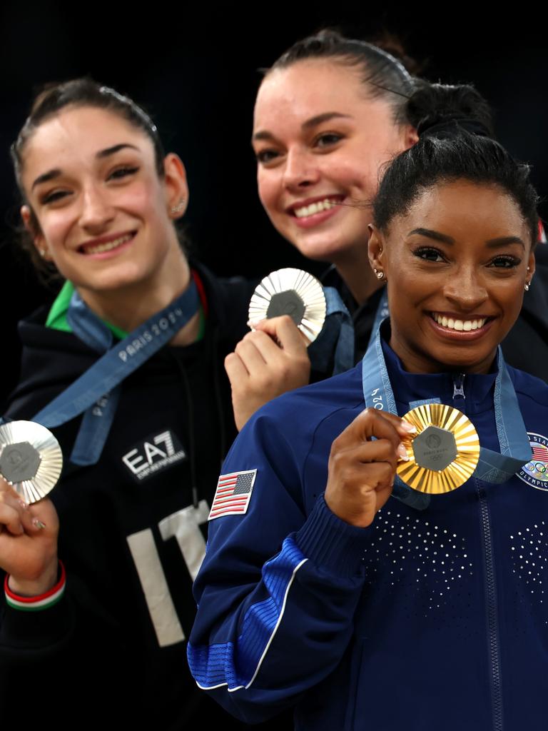 Elisa Iorio and Giorgia Villa of Team Italy and Gold medallist Simone Biles on the podium. (Photo by Naomi Baker/Getty Images)