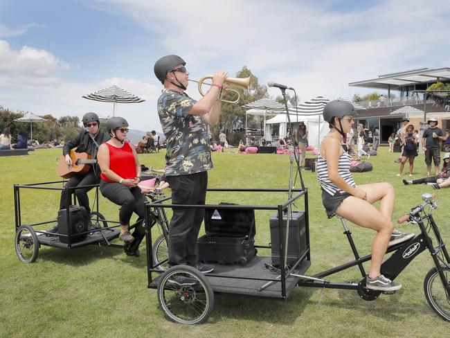 Musicians perform from the back of bicycles and make their way through crowds at Mona for Mona Foma. Picture: PATRICK GEE