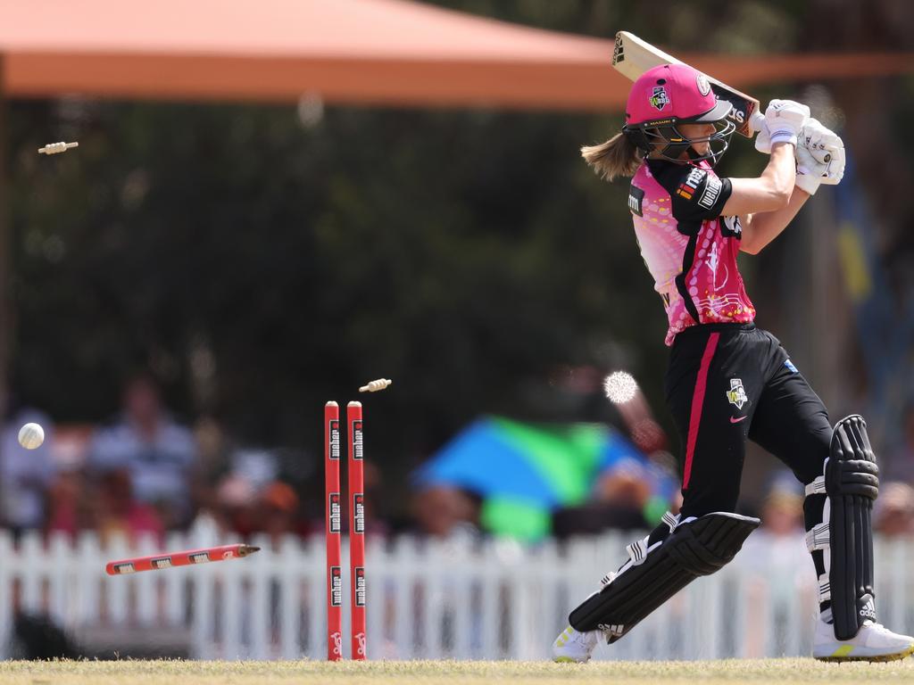 Ellyse Perry has her pegs ripped out during the Sixers’ innings. Picture: Getty Images