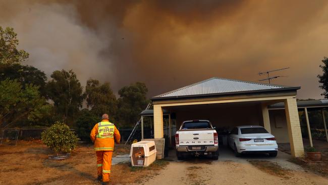 A firefighter in front of a bushfire in Tynong North. Picture: Alex Coppel