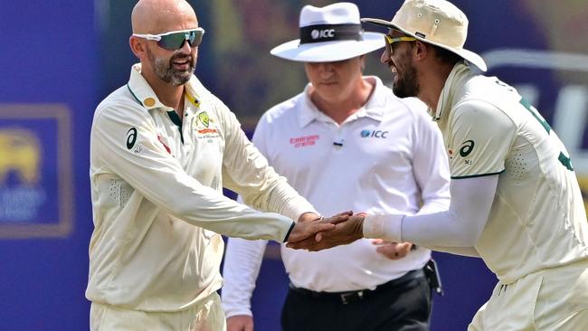 Australia's Nathan Lyon (L) celebrates with Mitchell Starc (R) after taking the wicket of Sri Lanka's Kusal Mendis during the fourth day of the first Test cricket match between Sri Lanka and Australia at the Galle International Cricket Stadium in Galle on February 1, 2025. (Photo by Ishara S. KODIKARA / AFP)