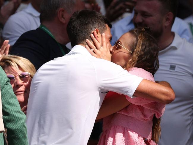 Serbia's Novak Djokovic kisses his wife Jelena Ristic after beating Australia's Nick Kyrgios during their men's singles final tennis match on the fourteenth day of the 2022 Wimbledon Championships at The All England Tennis Club in Wimbledon, southwest London, on July 10, 2022. (Photo by Adrian DENNIS / AFP) / RESTRICTED TO EDITORIAL USE