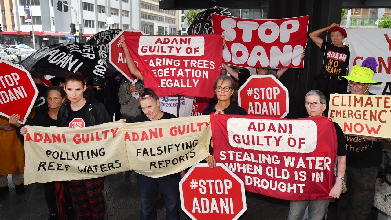 Anti-Adani coal mine protesters are seen at the Brisbane Magistrates Court in Brisbane in 2020 after the miner pleaded guilty to giving the Queensland government false or misleading information about land clearing activities. Picture: AAP Image/Darren England