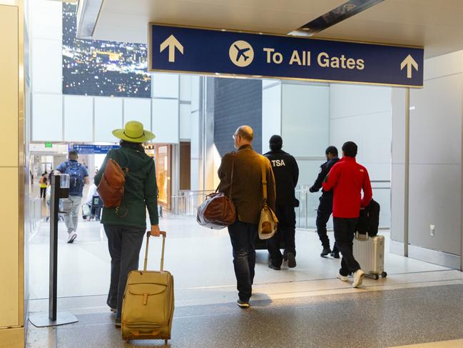 Los Angeles, California, USA, April 25, 2024- Directional sign to all gates at LAX airport with travelers walking.Escape 20 October 2024NewsPhoto - iStock