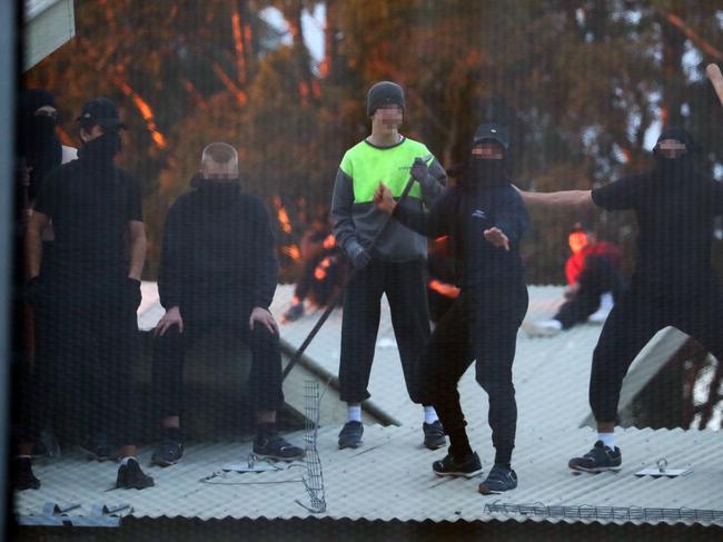 Inmates from the Frank Baxter Juvenile corrections centre Kariong taunt police from the roofs of various buildings. Some are armed with poles tennis rackets ect. Picture: John Grainger
