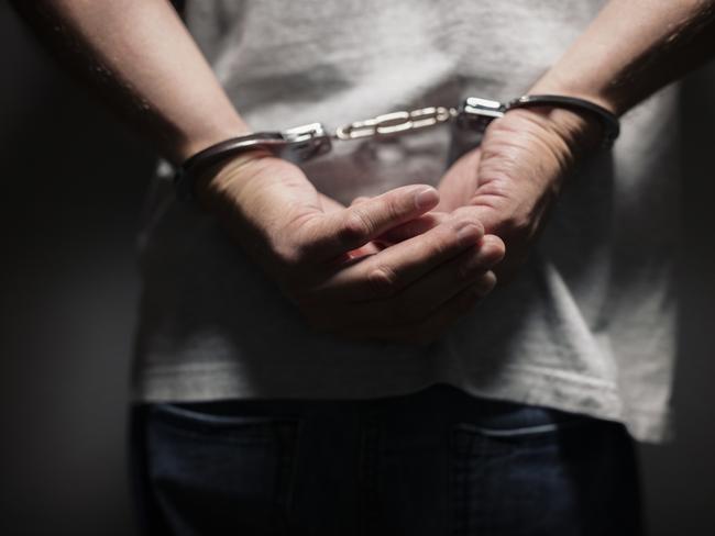 Arrested man in handcuffs with handcuffed hands behind back Picture: Istock