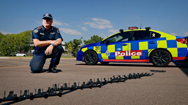 Road Policing Superintendent Daniel Shean demonstrates the Stinger tire deflation device, recently rolled out to NT Police officers on the front line.