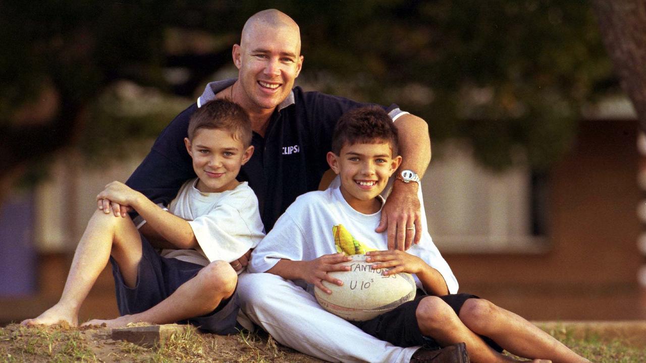 Craig Pierce with his sons Lachlan and Samuel photographed in 2002. Craig was preparing to play in the State of Origin touch football competition in the Qld men’s over 30s, two months after having a brain tumour removed.