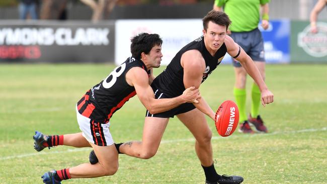 Rostrevor OC’s Tim Baccanello tackles Port District midfielder Trent Heffernan. The pair feature together in the centre line of the team of the year. Picture: AAP/Keryn Stevens