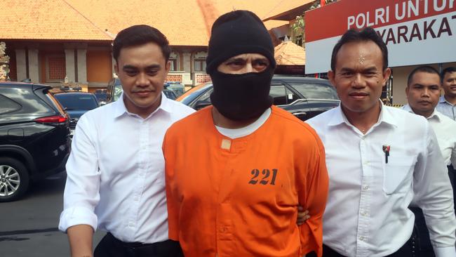 Lamar Ahchee is escorted by police from his cell to the interrogation room at Bali Police HQ. Picture: Lukman S. Bintoro